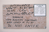 A warning sign for high levels of PCBs at an old DEW line station. Melville Peninsula, Nunavut, Canada. 1992