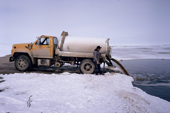 A truck empties a tank of human waste into a sewage lagoon near the Inuit community of Igloolik. Nunavut, Canada. 1992