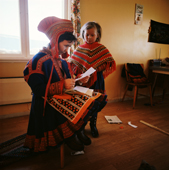 Sami woman, Berit Logje with her daughter Inga-Anna. She reads her school report. Kautokeino. Norway. 1972
