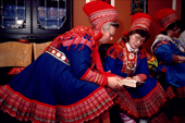 Sami women in traditional clothes share a prayer book at a christening service in Kautokeino. North Norway. 1990