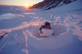 Fur clad Inuk, Qaaviganguaq, builds an igloo. It will be used as a hunting shelter. N.W. Greenland. 1980