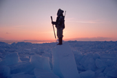 An Inuit hunter scans the ice of Melville Bay for polar bears. N.W.Greenland. 1986