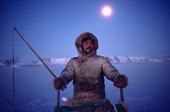 Ituko, an Inuit hunter travelling by dog sled during the polar night. N.W. Greenland. 1987