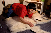 Mikivssuk Karlsen, an Inuit woman, making a pair of traditional polar bear skin trousers. N.W.Greenland. 1998