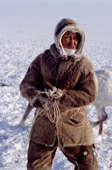 Innikentiy Zharkov, a Dolgan herder, coils his lasso during a round up of reindeer on the tundra. Taymyr, Northern Siberia, Russia. 2004