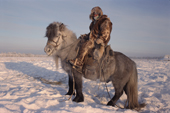 A Yakut horse herder riding in the winter time near Verkhoyansk. Yakutia, Siberia, Russia. 1999