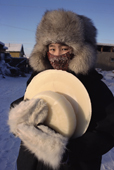 Lena Potapova carrying frozen milk back to her home in Verkhoyansk. Yakutia, Siberia, Russia. 1999