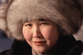A young Yakut woman dressed for winter's cold in a fox fur hat coat. Yakutsk, Yakutia, Siberia, Russia. 2001