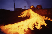 Red hot slag from a nickel foundry in Norilsk glows at dusk. Western Siberia, Russia. 2000