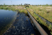 Oil spilling from pipes and polluting a lake near Niznevartovsk, Khanty Mansiysk, W. Siberia, Russia. 2000