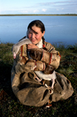 Alya, A Nenets girl, poses with her pet cygnet at a summer camp near Nadym, Yamal, W.Siberia, Russia. 2000