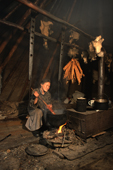 Nyaluku, a Nenets woman cooking fish inside her tent at a summer fishing camp. Yamal, W.Siberia, Russia. 2000