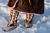 A Khanty woman, wearing traditional winter reindeer skin boots with an ornate design pattern. Numto, Khanty Mansiysk, Northwest Siberia, Russia