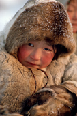 Neseinye Serotetto, a Nenets girl, with almond eyes & rosy cheeks dressed warmly in reindeer skin clothing. Yamal. Siberia. Russia. 1993