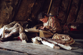 Vera Khudi, a Nenets woman, sewing A Nenets woman sewing a pair of reindeer skin reindeer skin boots inside her tent. Yamal. Siberia. Russia. 1993
