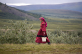Kristina Neyva, a Khanty woman, carrying water to her family's camp in Polar Ural Mountains. Yamal, Western Siberia, Russia