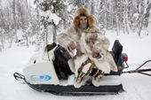 Kosta, a Selkup hunter, rests on his snowmobile while out checking his sable traps in the forest. Krasnoselkup, Yamal, Western Siberia, Russia. (2012)