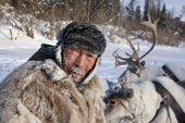Gennadiy Kubolev, a Selkup hunter, with his draft reindeer on the frozen Shirta River. Krasnoselkup, Yamal, Western Siberia, Russia. (2012)
