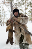 Gennadiy, an elderly Selkup hunter, removes a sable caught in a leghold trap. Krasnoselkup, Yamal, Western Siberia, Russia. (2012)
